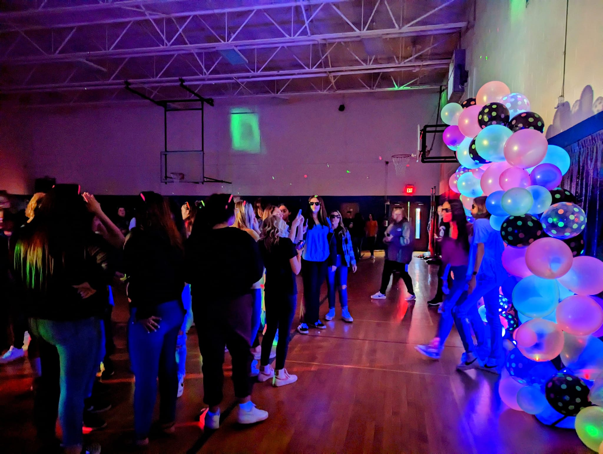 Neon lights in gym with people dancing
